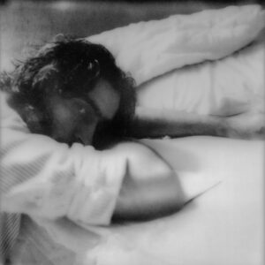 Self portrait of Hamza resting on his forearm, shot on black and white film.